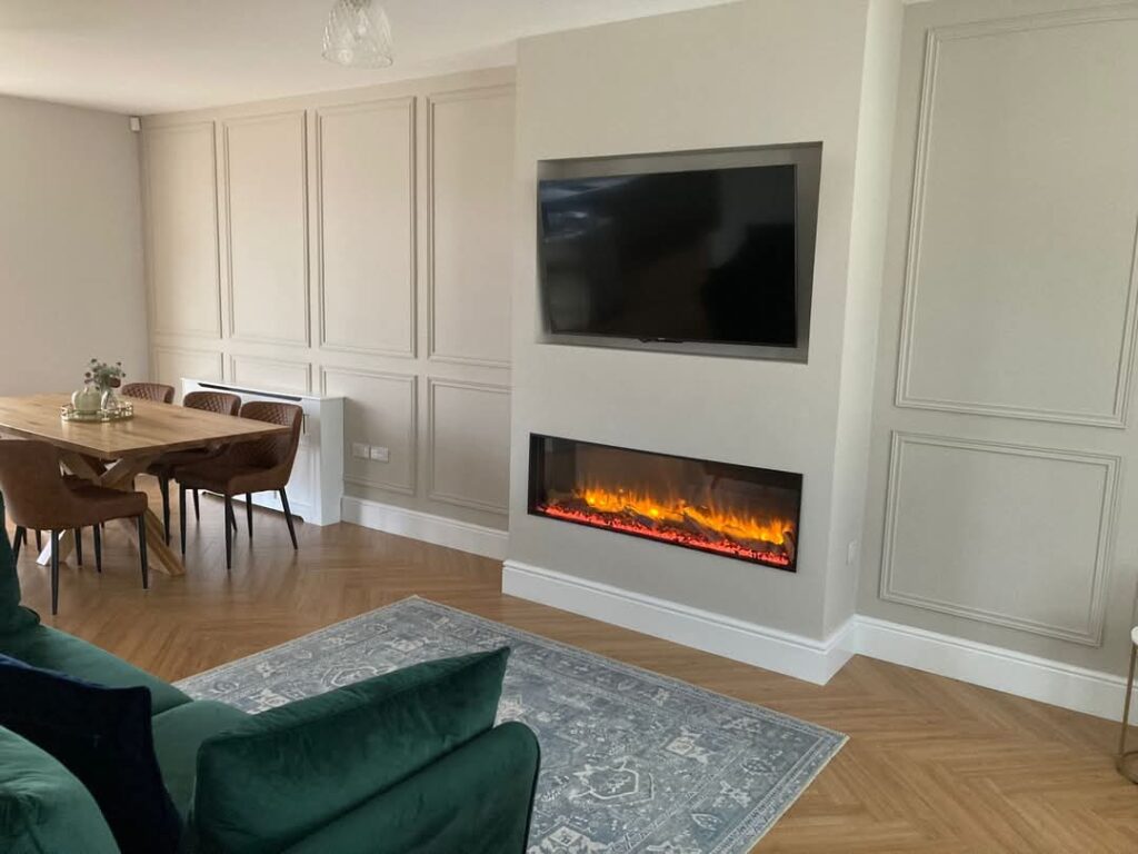 Living room with framed wall mouldings, wooden dining table, fireplace, and TV.
