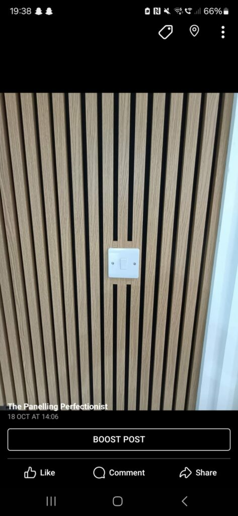 Wooden panel wall with a white light switch in the center.