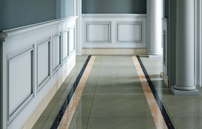 Elegant corridor with light gray wall paneling and glossy tiled floor.